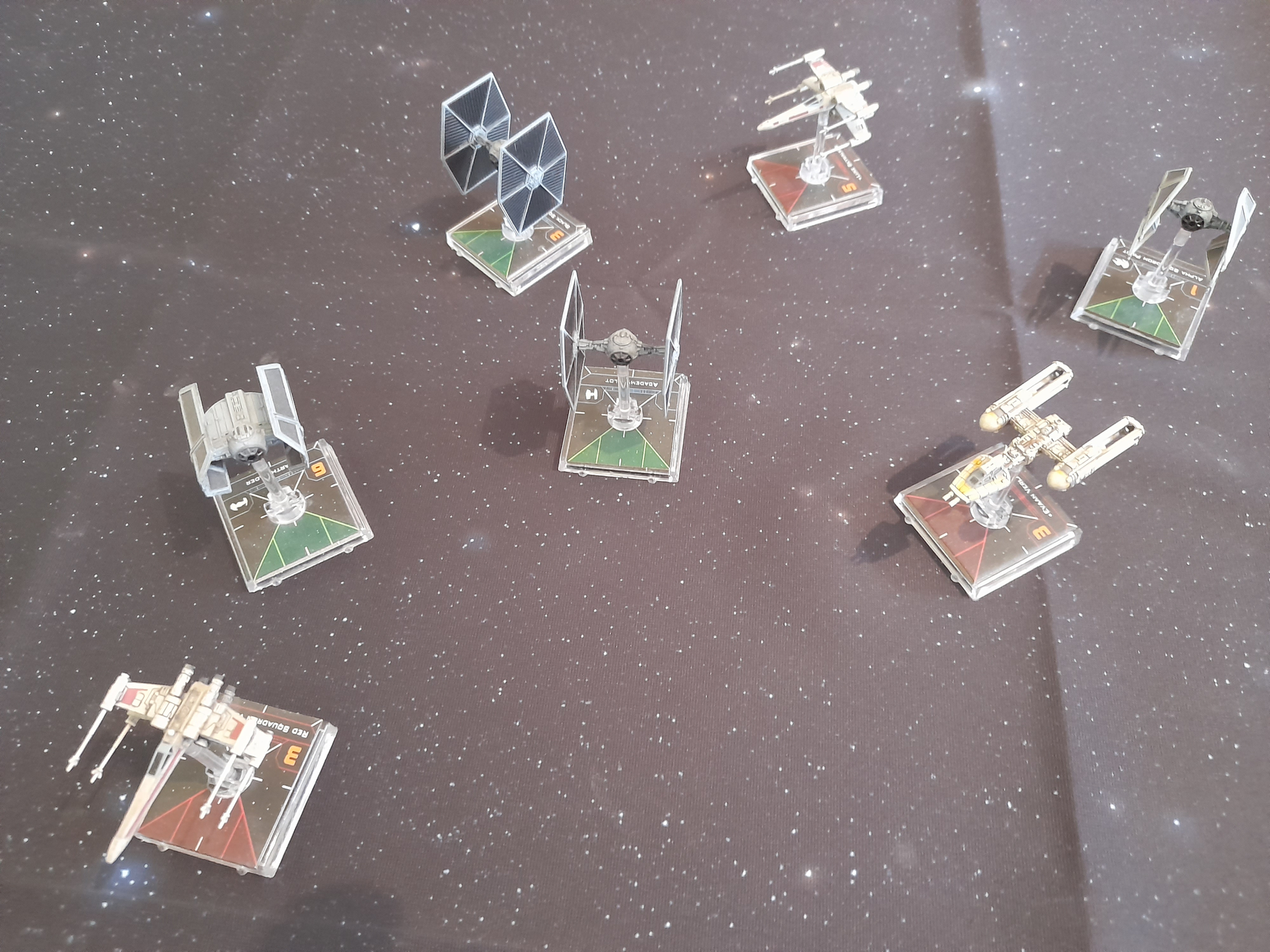 A Dogfight between two X-wings and a Y-Wing vs four TIE Fighters fromn the Star Wars X-Wing Minatures Game